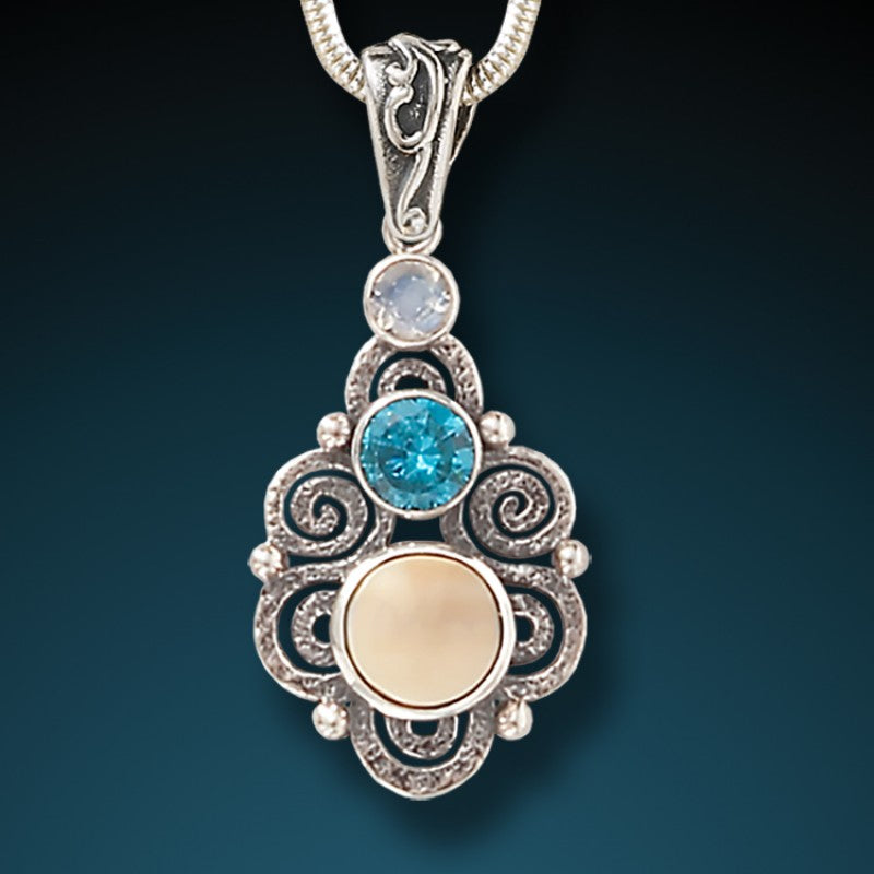 "Stardust" Fossilized Walrus Tusk, Blue Topaz, and Moonstone and Sterling Silver Pendant